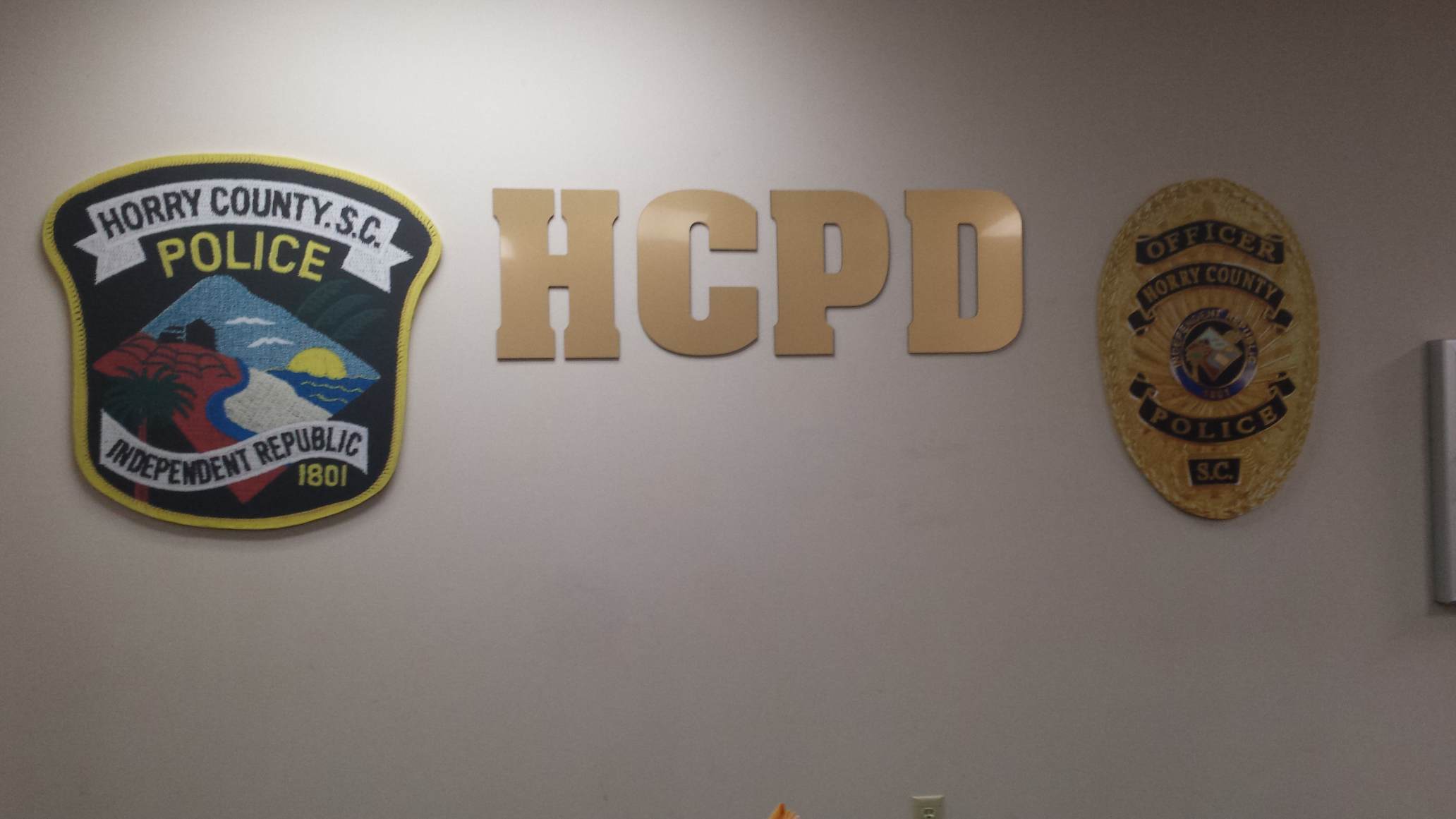 HCPD emblem and badge on wall