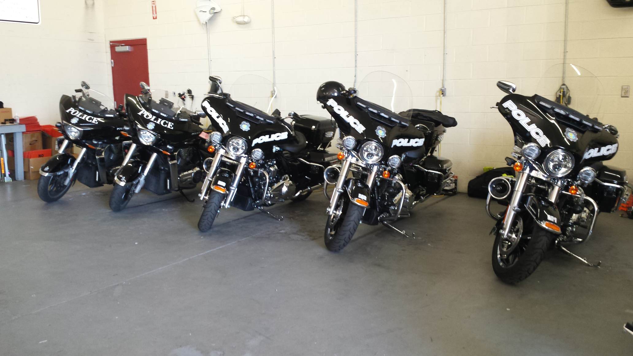 Police motorcycles lined up in garage