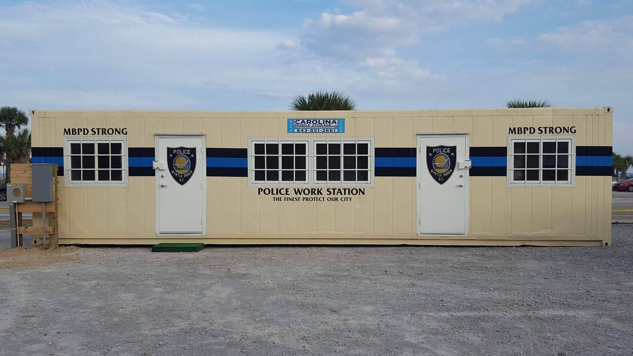 Mobile police unit on gravel lot