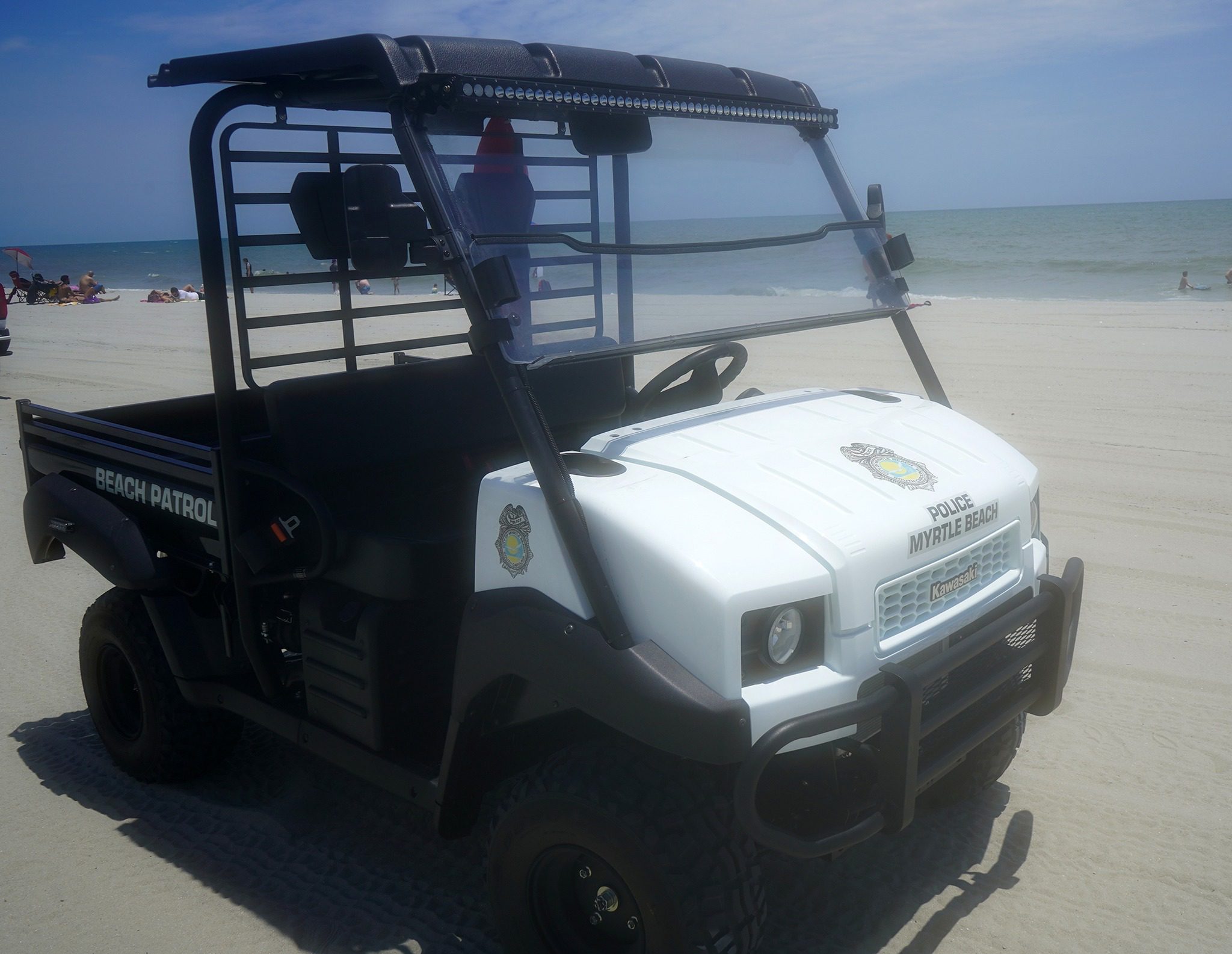 Beach patrol vehicle on sandy shore